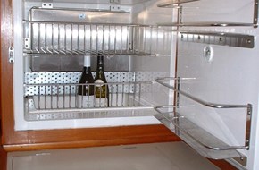 Refrigerator wall installation with holdover plate